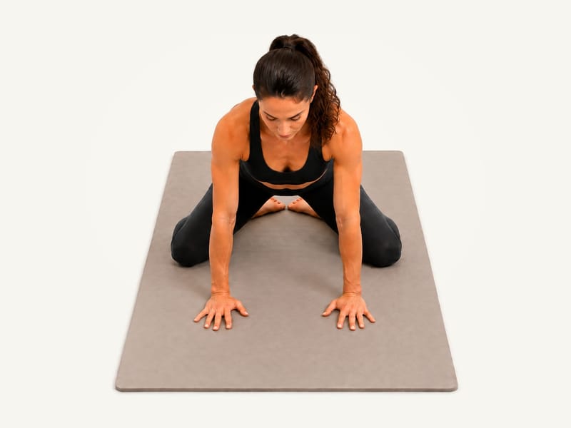 Child's pose set-up: kneeling on all fours with the big toes together and the knees apart