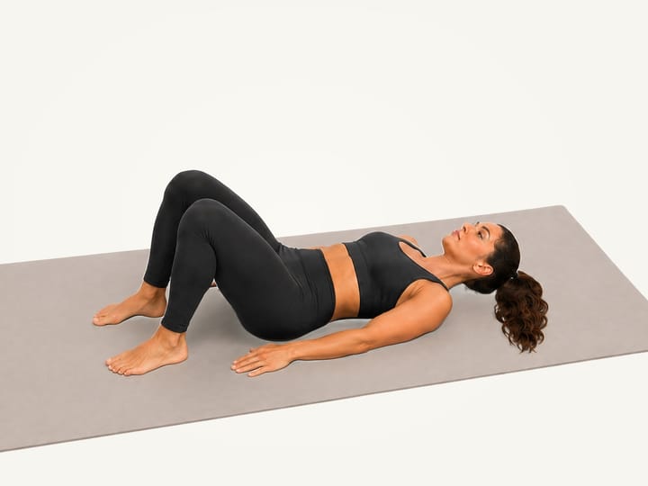 Step 1 of the figure 4 stretch: lying on the back, knees bent and feet flat