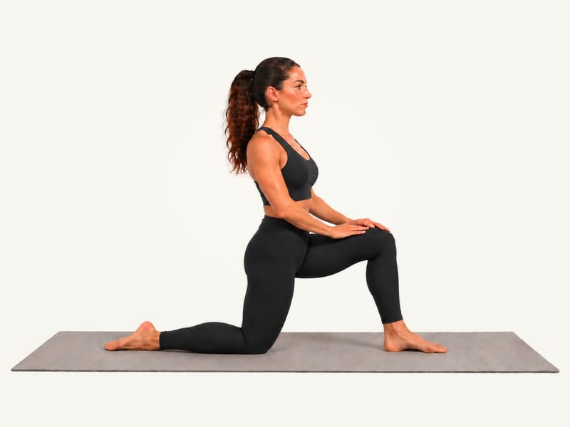 Kneeling hip flexor stretch set-up: half-kneeling on the right knee, left foot forward, hands on the left thigh