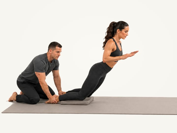 Step 2 of the Nordic curl: lowering forward from the knees, hips and trunk in line, hands ready