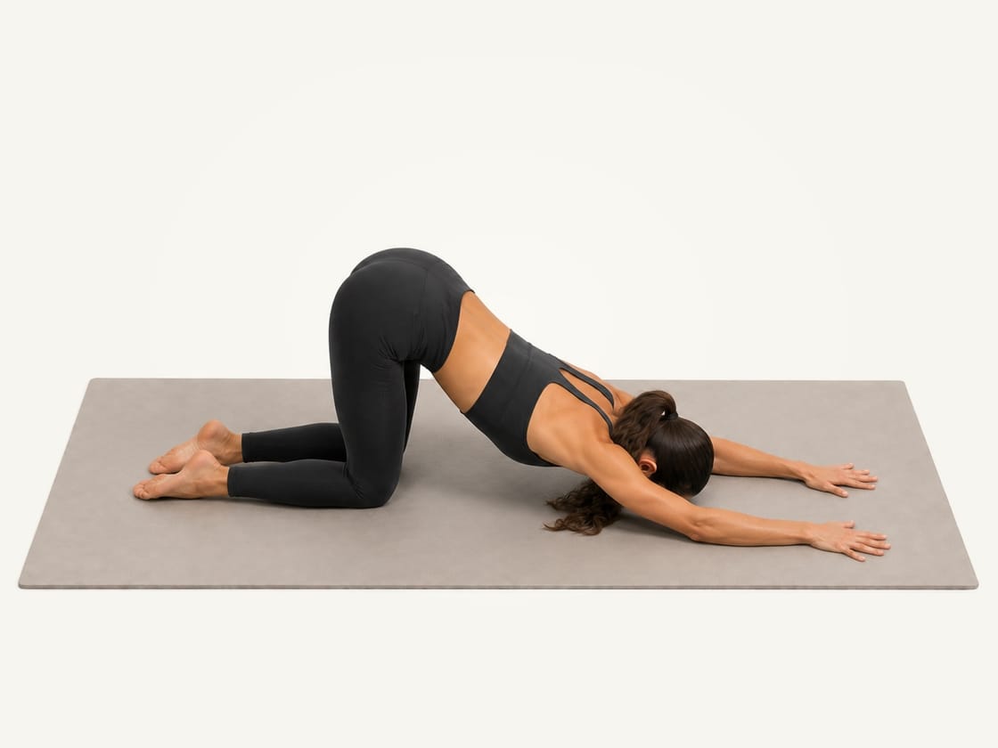 Puppy pose: hips above the knees, arms long in front and the chest lowered towards the mat