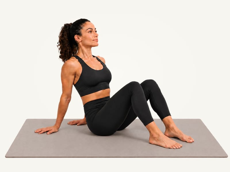 Seated figure 4 stretch set-up: sitting on the mat, knees bent, feet flat, palms behind