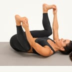Happy baby pose: lying on the back holding both feet, knees bent wide